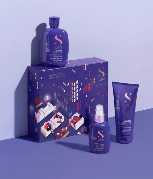 Purple hair care product set with packaging on a blue background