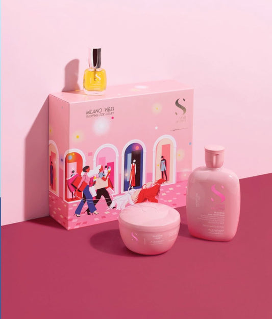 Pink cosmetic set with a box, bottle, and jar on a pink background