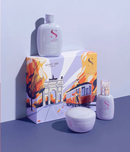 Hair products including bottles and a jar with a decorative box on a purple background
