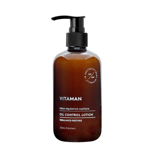Brown bottle of Vitaman oil control lotion with pump background