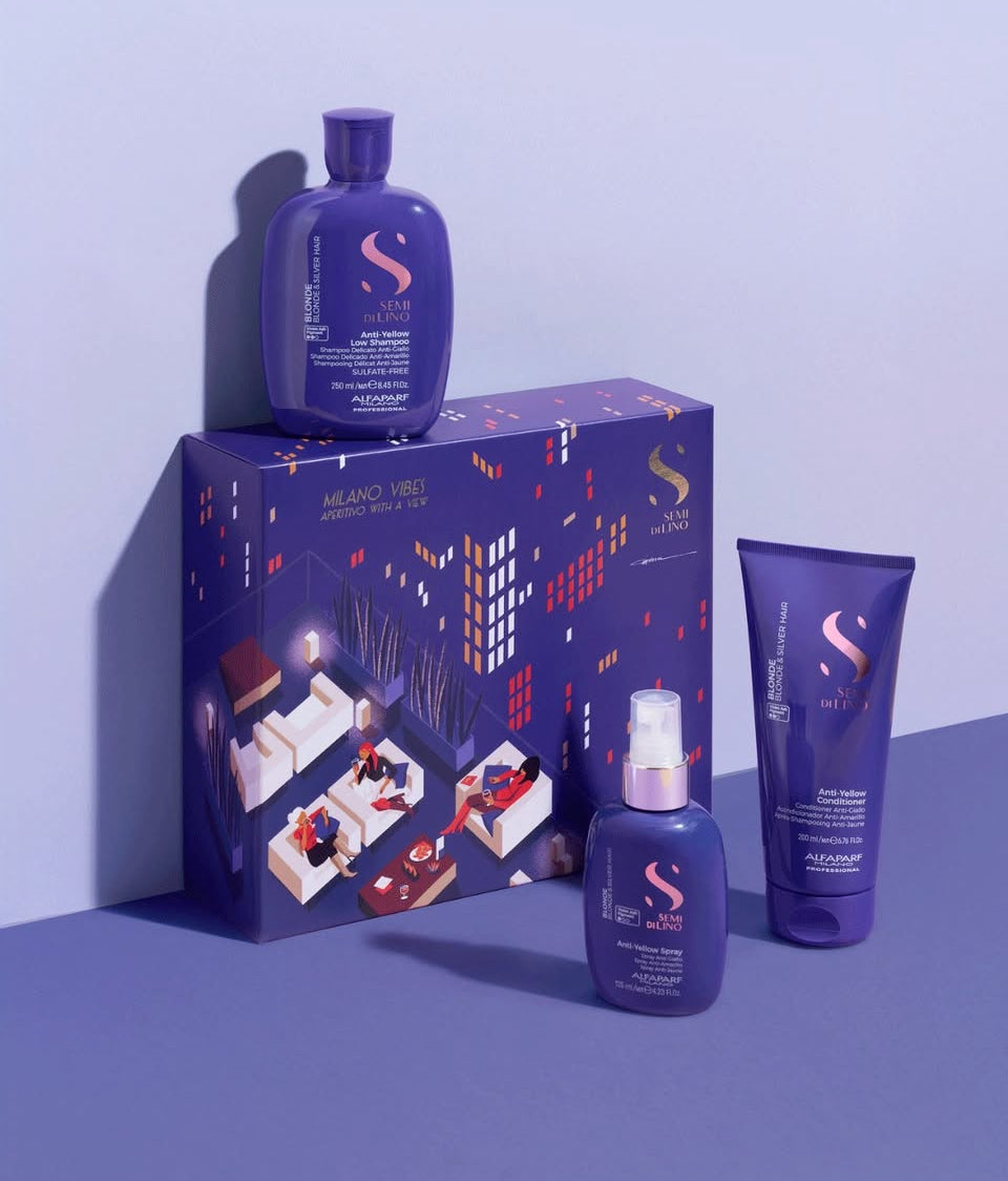Purple hair care product set with packaging on a blue background